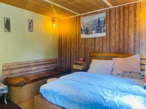 a bedroom with a bed with a wooden head board at Biafo Resort Skardu in Skardu