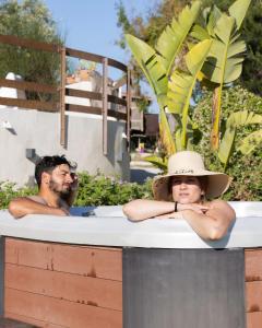 a man and a woman in a bath tub at Ciriga Sicily Glamping in Santa Maria Del Focallo