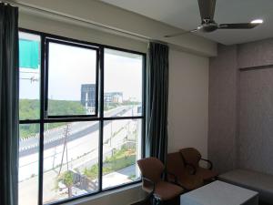 a room with a large window with a view of a street at Hotel Vista Airport Zone in Shamshabad