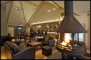 a living room with a fireplace in the middle at 6, The Gallops, Mains of Taymouth Estate, Kenmore in Kenmore
