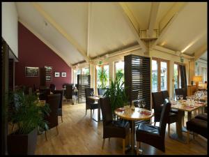 a restaurant with tables and chairs in a room at 6, The Gallops, Mains of Taymouth Estate, Kenmore in Kenmore