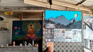 a wall with a large mural of a buddha at Nirvana hotel , near by hot springs in manali bashisht in Vashisht