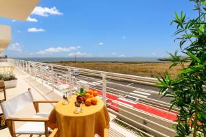 a table on a balcony with a view of the ocean at Marzamemi Holidaydream Sea View in Marzamemi