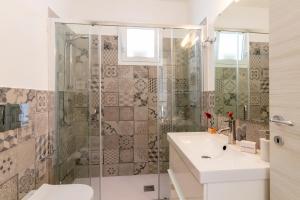 a bathroom with a sink and a shower at Marzamemi Holidaydream Sea View in Marzamemi