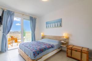 a bedroom with a bed and a large window at Marzamemi Holidaydream Sea View in Marzamemi