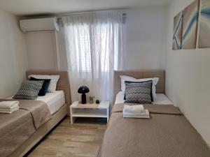 Postel nebo postele na pokoji v ubytování Apartments Ivica