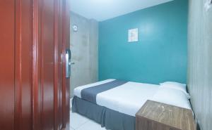 Voodi või voodid majutusasutuse Rcee Place by RedDoorz toas