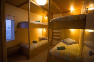 a room with two bunk beds and a window at KILIMANJARO ALPINE APARTMENTS 3 BEDROOM Apartment in Falls Creek