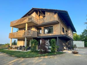 a large wooden house with a balcony at Das Gretlnest - Premium Naturrefugium in Gamlitz