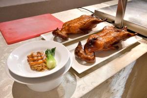 a table with three different types of food on plates at Whistler Garden Hotel in Sungaitahang +4 photos