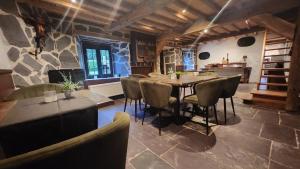 a dining room with a table and chairs at La Ferme Aux Bois in Houffalize