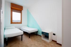 A bed or beds in a room at Belvedere Lido Adriano