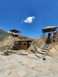 a house on a hill with stairs in front of it at The Adventurers Resort in Dhechiān di Bahlk
