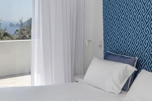 a hotel room with a bed and a window at Relais Blu in Massa Lubrense