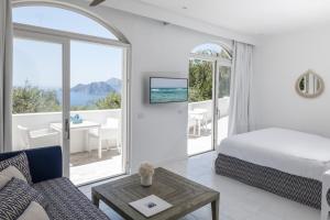 a bedroom with a bed and a view of the ocean at Relais Blu in Massa Lubrense