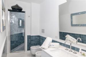 a bathroom with a toilet and a sink and a shower at Relais Blu in Massa Lubrense
