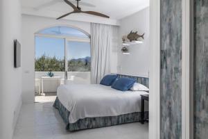 a bedroom with a bed and a large window at Relais Blu in Massa Lubrense