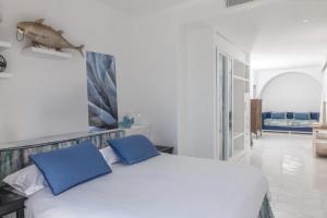 a bedroom with a bed with two blue pillows at Relais Blu in Massa Lubrense