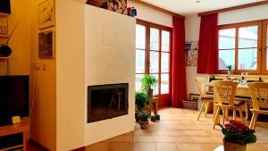 a living room with a fireplace and a table at Bergzicht in Mariapfarr