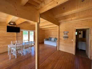 a dining room in a log cabin with a table and chairs at Melides Nature & Beach in Melides