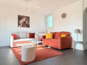 a living room with two couches and a table at La Renaissance in Bayeux +17 photos