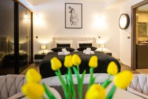 a bedroom with a bed with yellow flowers in the foreground at Zen Retreat Studio in Silver Mountain in Poiana Brasov +30 photos