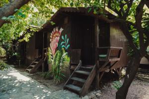 a small house with a mural on the side of it at Base Bungalows in Olympos