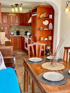 a kitchen with a wooden table with plates on it at Mary's Archontiko in Mesaria