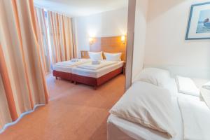 a hotel room with a bed and a couch at Bodensee Yachthotel Schattmaier in Kressbronn am Bodensee +22 photos