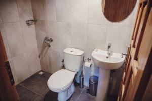 a small bathroom with a toilet and a sink at Base Bungalows in Olympos