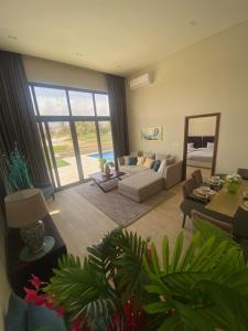 a living room with a couch and a table at Villa Rotana Tulip in Salalah +24 photos