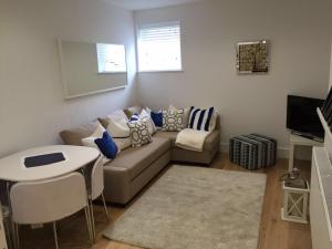 a living room with a couch and a table at Lincoln Retreat in Lincoln