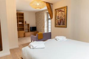 a hotel room with a bed and a chair at Armance in Mont-Saint-Jean +20 photos