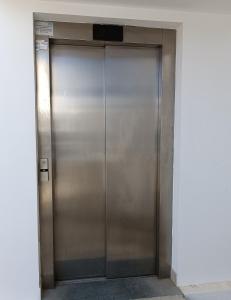 a large metal elevator door in a building at Georgia Hotel Apartments in Protaras