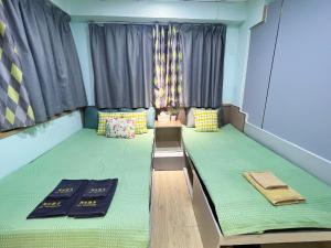 Postel nebo postele na pokoji v ubytování AMU Dreamhouse 阿木旅舍