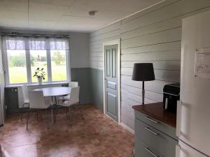 a room with a table and chairs and a window at Bockekulla Gård in Bergkvara
