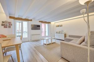 a living room with a couch and a table at El Mirador de la Estafeta by Clabao in Pamplona