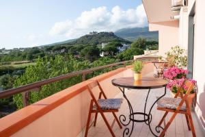 a balcony with a table and chairs and a view at Tra il Vesuvio e il Mare Apartment in Torre del Greco