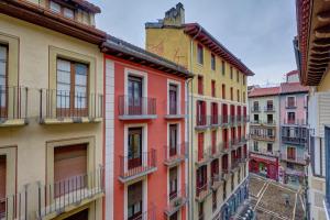 a row of colorful buildings in a city at El Mirador de la Estafeta by Clabao in Pamplona