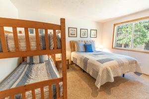a bedroom with two bunk beds and a window at Warbler - Unit 15 in Sunriver +93 photos