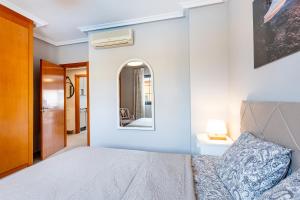 a bedroom with a bed and a mirror at Del Duque Ocean View Terrace in Adeje +21 photos