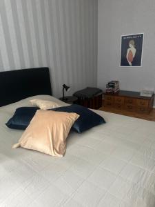 a bedroom with a large bed with two pillows at Rantaraitti in Savonlinna