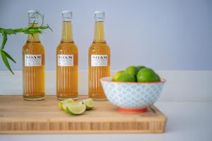 three bottles of lemon essential oils and a bowl of apples at The Art Loft in Kingsbridge +34 photos