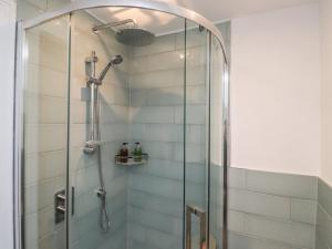 a shower with a glass door in a bathroom at Puffin Cottage in Alnwick +34 photos