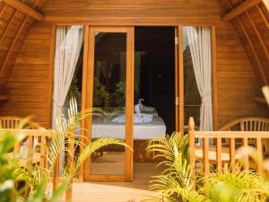 an open door to a room with a bed outside at Loka Sea View Glamping in Pengastulan