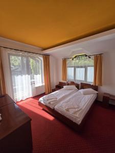 a bedroom with a bed and a large window at Casa Maria Azuga by Genco in Azuga