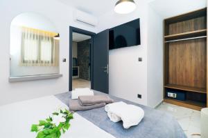 a living room with a table with towels on it at Glaroi 2 in Pefkohori +53 photos