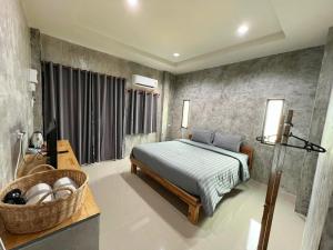 a bedroom with a bed and a basket in it at Samanta By The Hill in Ko Larn +20 photos