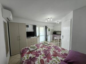 a bedroom with a bed with a floral bedspread at Countryside Studio Apartment Valentina in Vrh