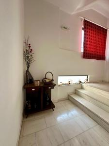 a living room with a table and a window at Papaioannou Aparts in Loutra Edipsou